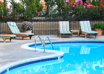 Swimming Pool Surrounded by Lounge Chair Swimming Pool Surrounded by Lounge Chair